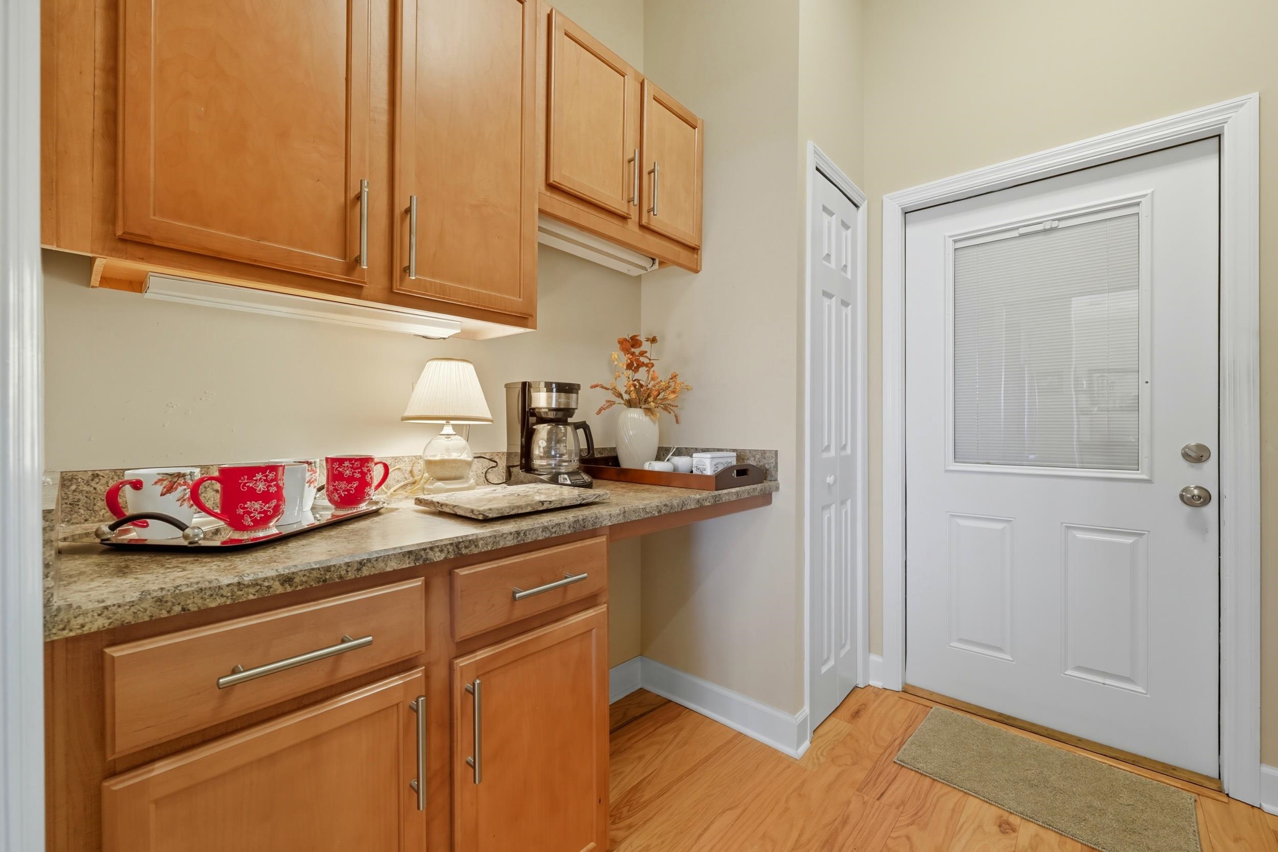 305 Marsh Point Circle St. Augustine, FL 32080 - Photo 39 of 82 a kitchen with stainless steel appliances granite countertop a sink dishwasher and cabinets with wooden floor