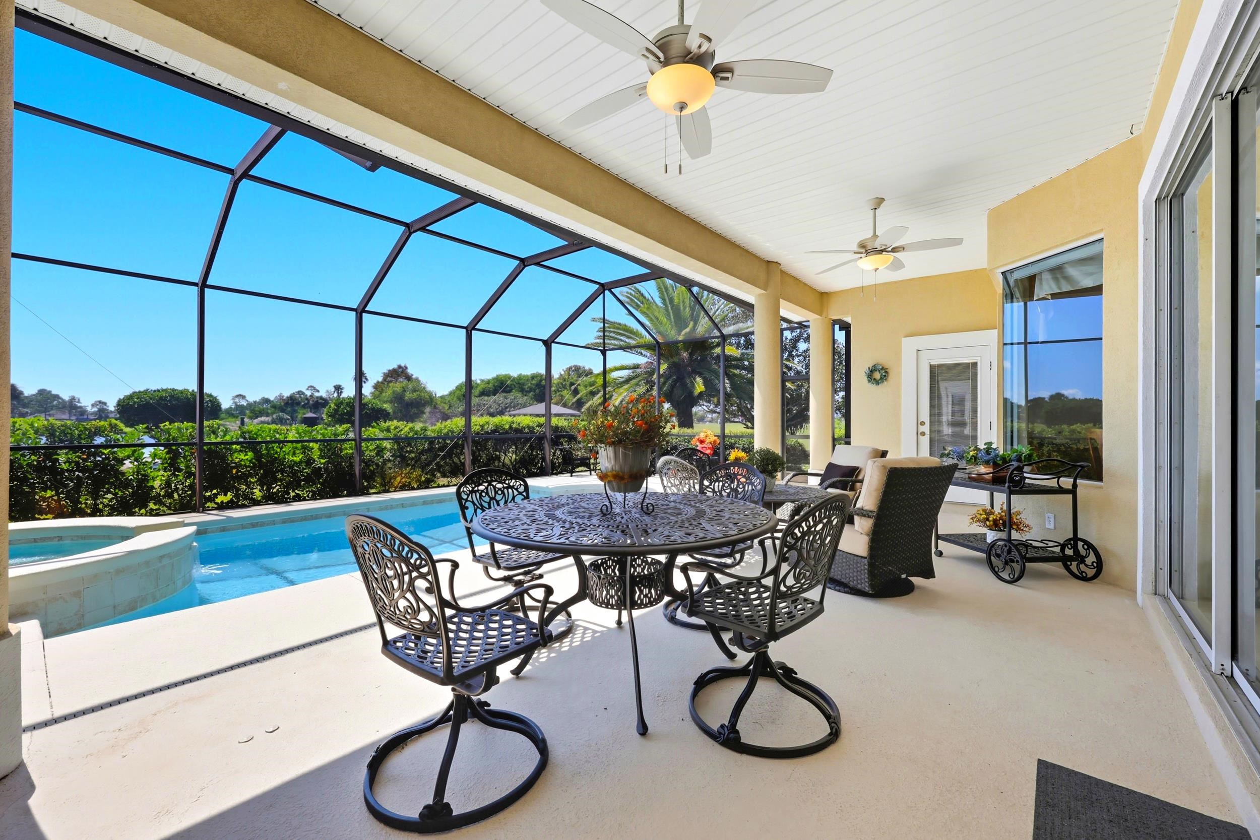 305 Marsh Point Circle St. Augustine, FL 32080 - Photo 41 of 82 View of pool featuring a sunroom, a pool with connected hot tub, glass enclosure, ceiling fan, and a patio area