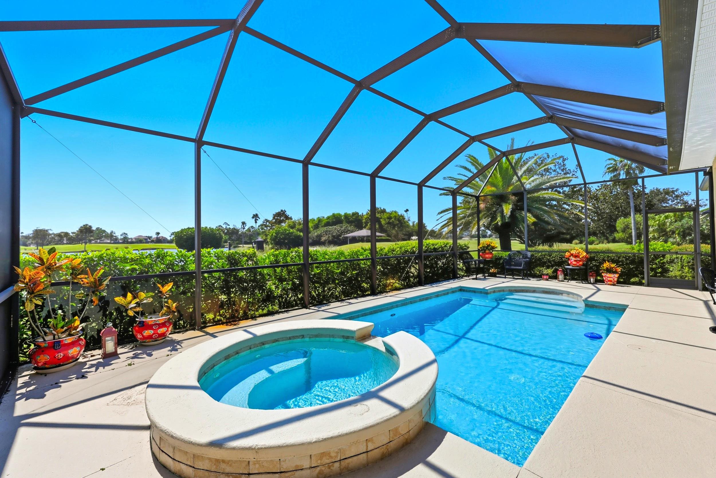 305 Marsh Point Circle St. Augustine, FL 32080 - Photo 48 of 82 View of swimming pool with a pool with connected hot tub, a sunroom, a patio, and glass enclosure