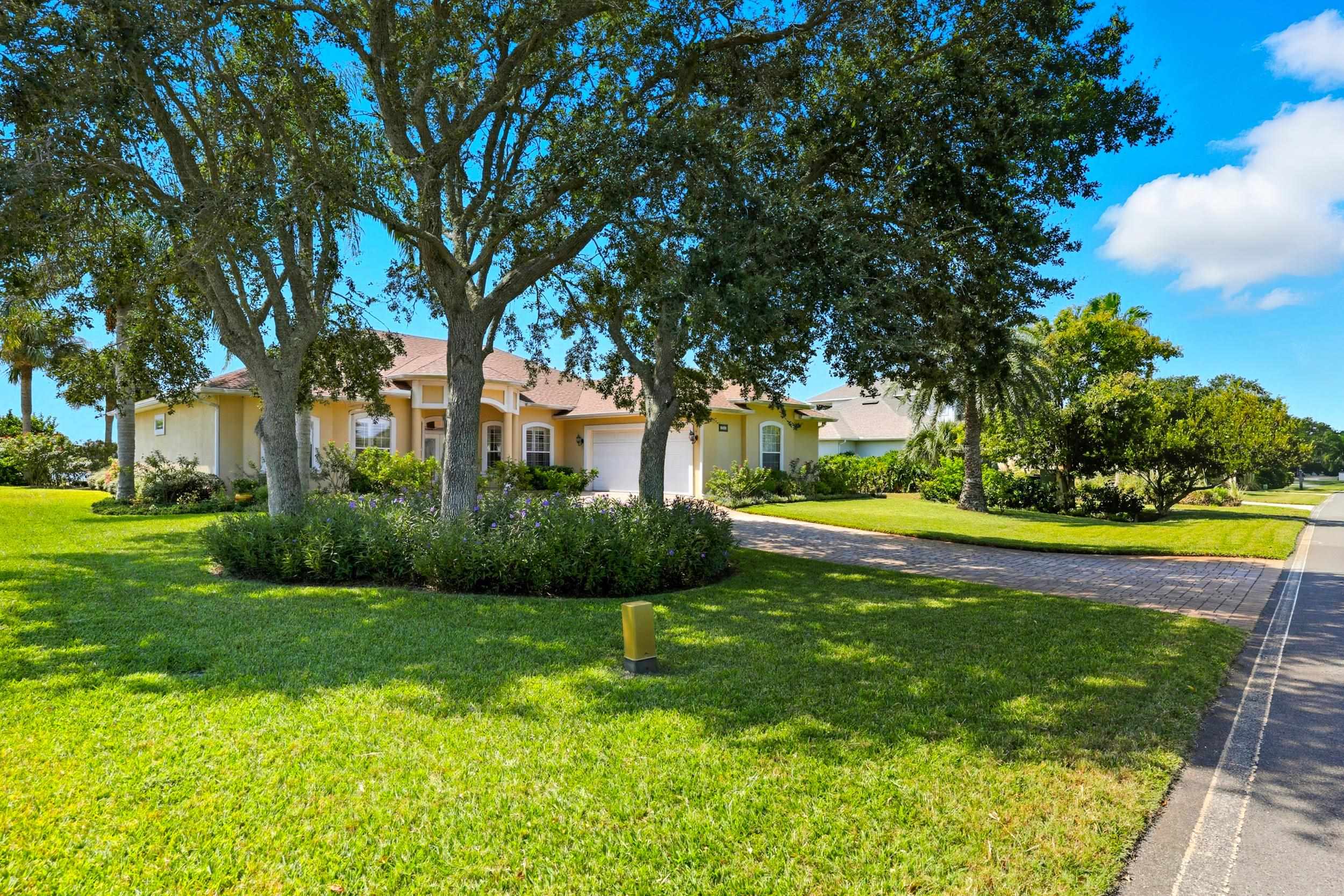 305 Marsh Point Circle St. Augustine, FL 32080 - Photo 54 of 82 a view of a swimming pool and a yard with plants and large trees