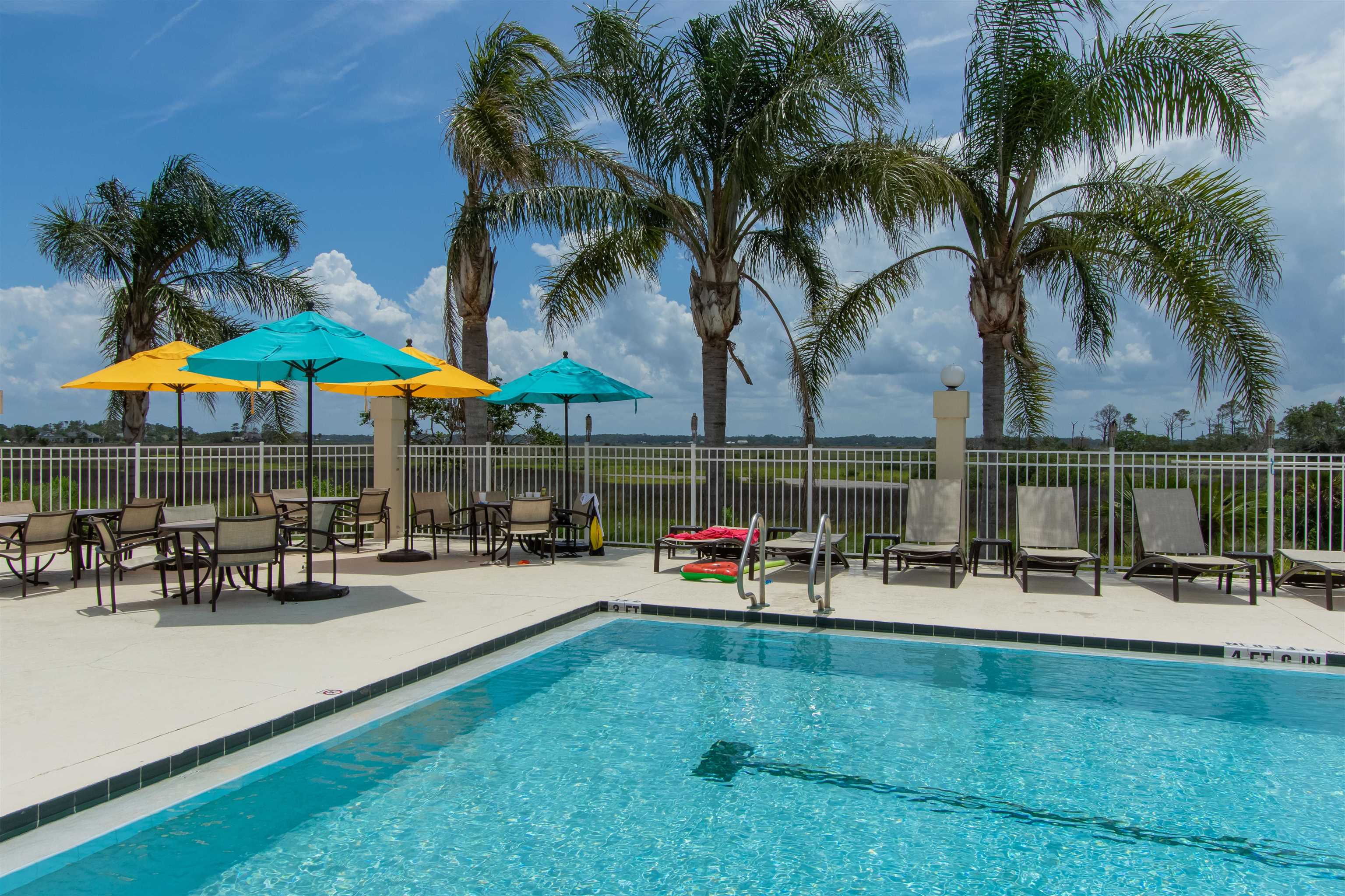 305 Marsh Point Circle St. Augustine, FL 32080 - Photo 78 of 82 a couple of table and chairs under an umbrella in front of house