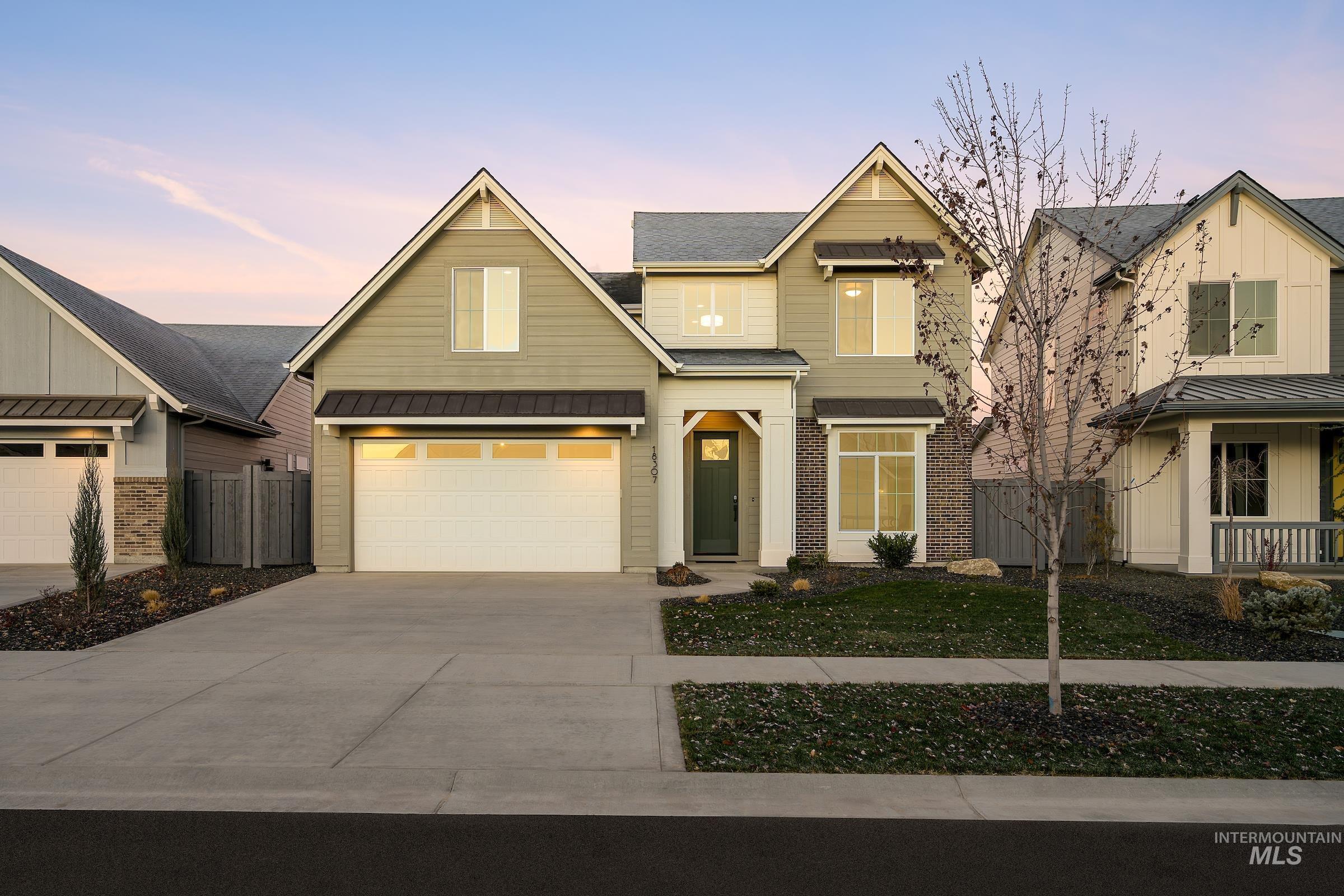 View of front of home featuring an attached garage and concrete driveway