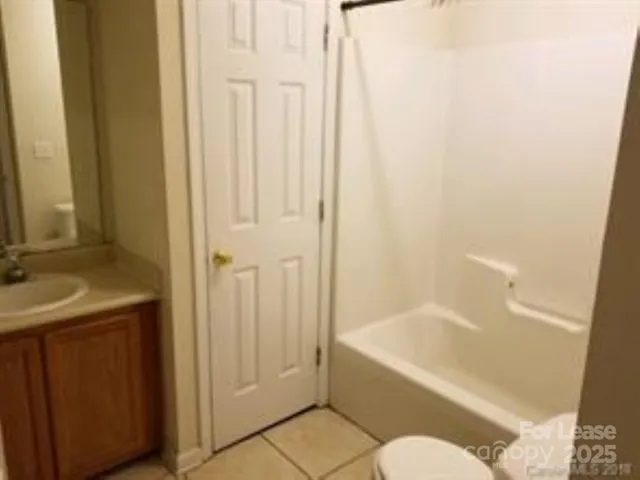 a bathroom with a sink and bathtub with toilet