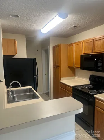a kitchen that has a sink and a stove top oven