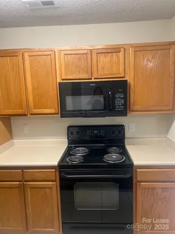 a stove top oven sitting inside of a kitchen