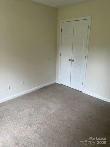 a view of an empty room and closet area