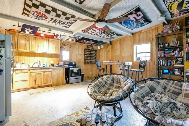 a living room with furniture a wooden floor and next to a window