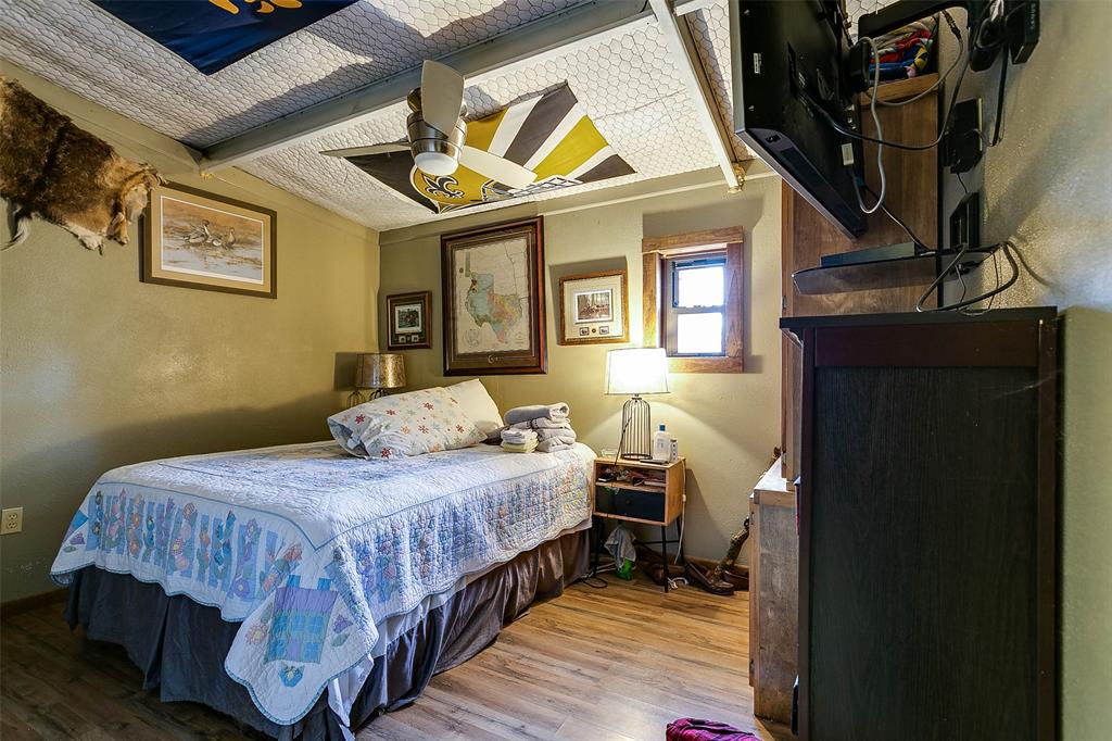 Na Cox Road Robert Lee, TX 76945 - Photo 25 of 40 a bedroom with a bed and wooden floor