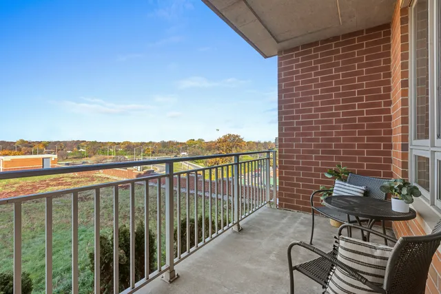 a view of a balcony with an outdoor seating