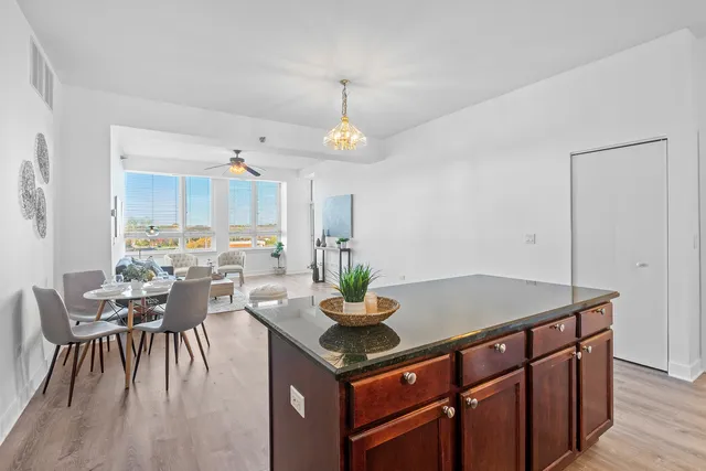 a kitchen with a table chairs and white cabinets