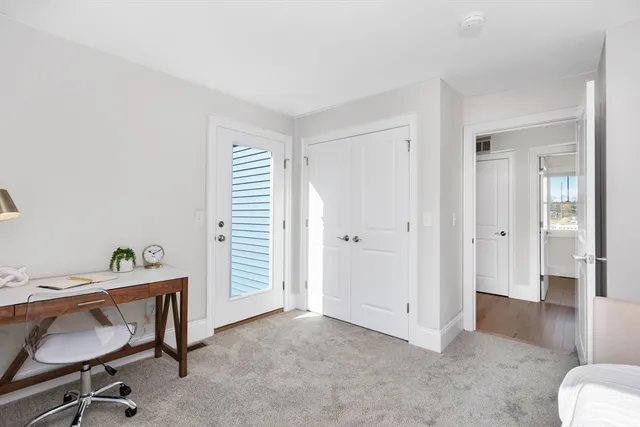 a view of a room with workspace and a window