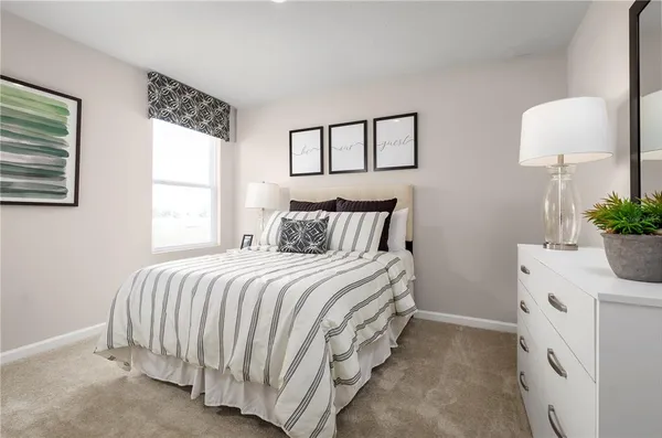 a bedroom with a bed and a potted plant