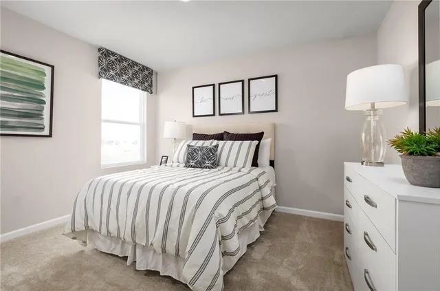 a bedroom with a bed and a potted plant