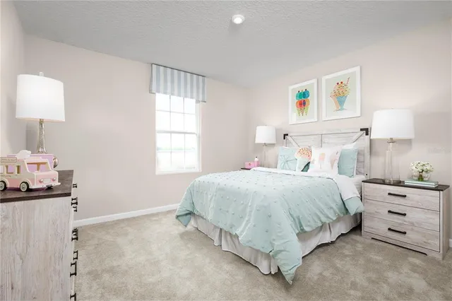 a spacious bedroom with a bed and a window