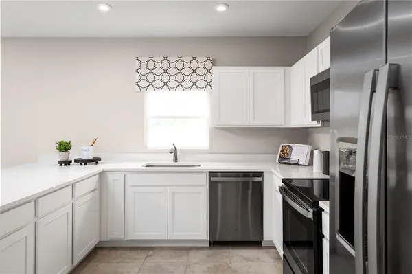 a kitchen with a sink stove and refrigerator