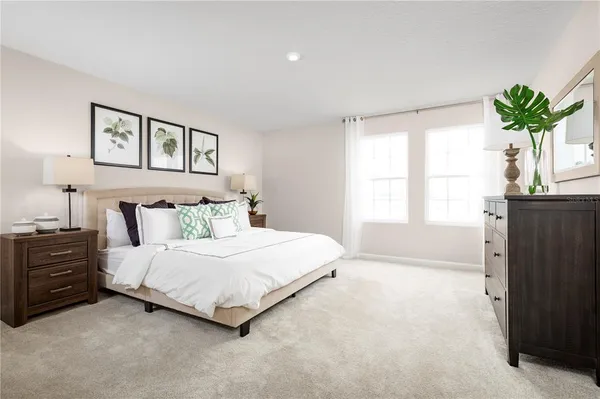 a bedroom with a bed and a potted plant