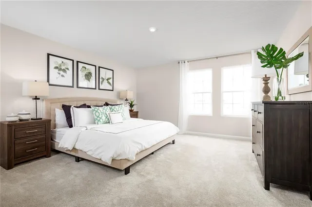 a bedroom with a bed and a potted plant