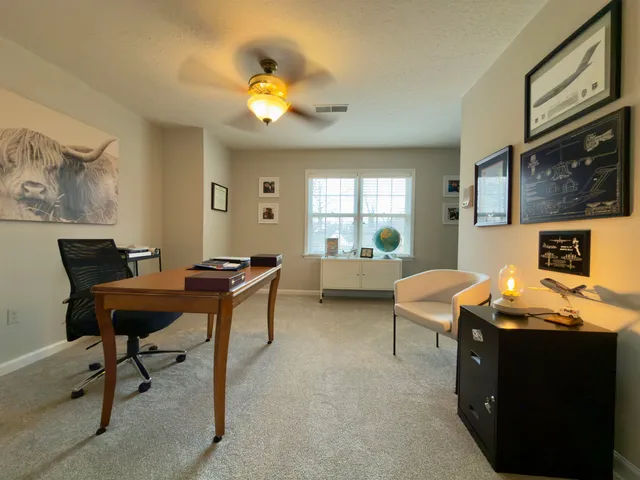 a work room with furniture and a chandelier