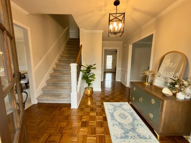 a view of entryway and hall with wooden floor