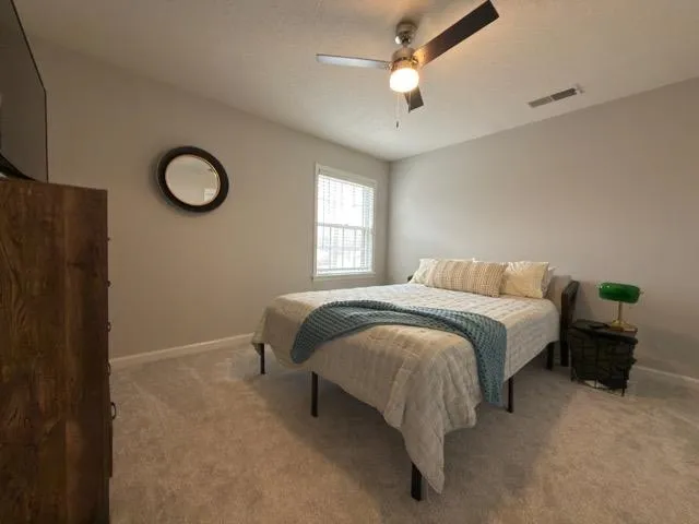 a bedroom with a bed and chandelier