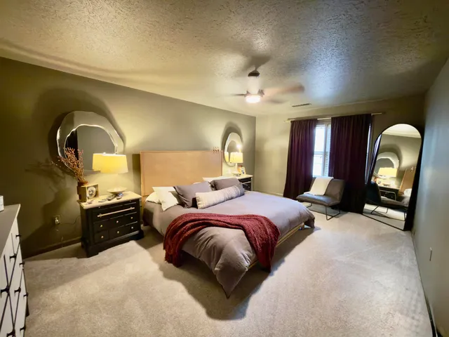 a bed room with a bed and a double vanity