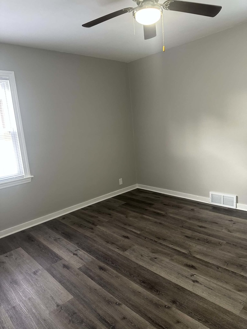 513 Cookane Avenue Elgin, IL 60120 - Photo 12 of 26 a view of a room with wooden floor and window