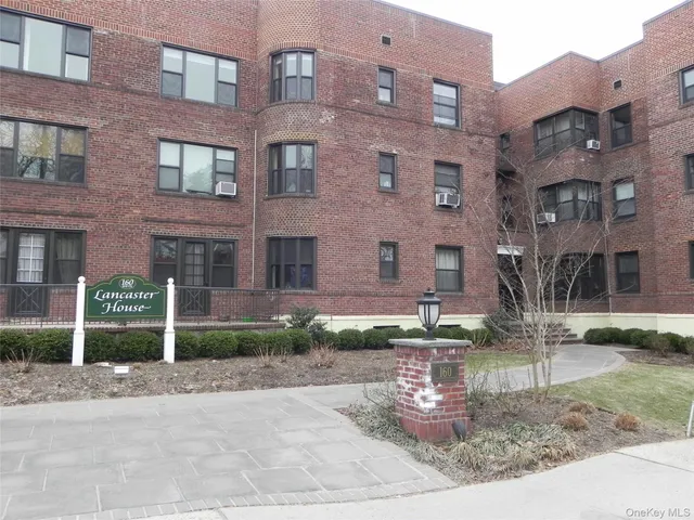 a view of a brick building with many windows