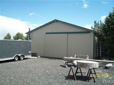 9500 South W Riggs Road Powell Butte, OR 97753 - Photo 15 of 22 a backyard of a house with table and chairs