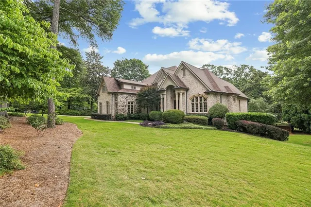 a front view of a house with garden