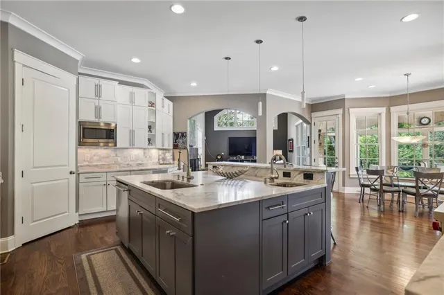 a kitchen with sink stove and cabinets