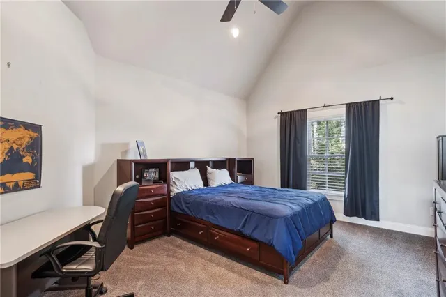 a bedroom with a bed a desk and chair