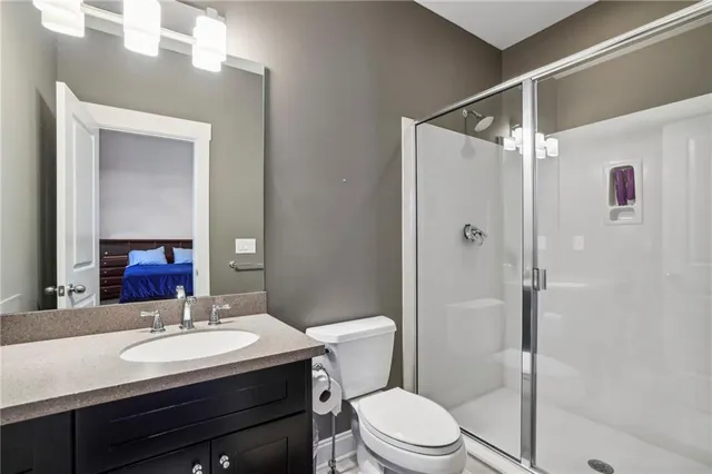 a bathroom with a sink toilet vanity and shower