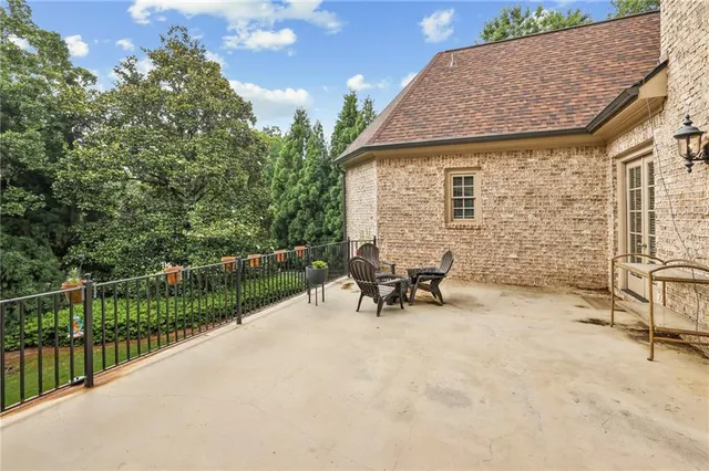 a view of a terrace with chairs and wooden fence
