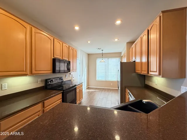 a kitchen with stainless steel appliances a sink stove and cabinets
