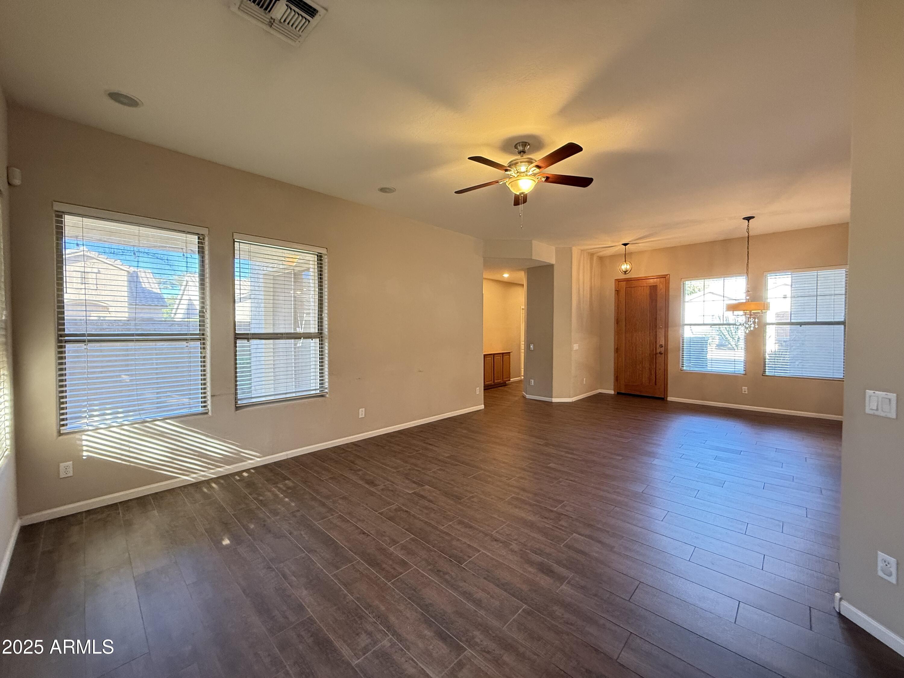 4805 East Wagoner Road Scottsdale, AZ 85254 - Photo 6 of 12 a view of an empty room with a window and wooden floor