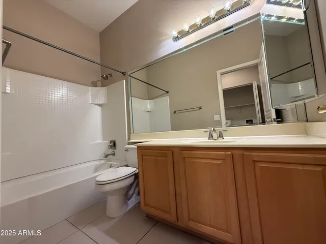 a bathroom with a double vanity sink toilet and shower