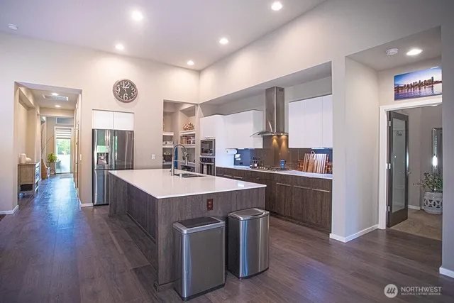 a kitchen with stainless steel appliances granite countertop a stove and a refrigerator