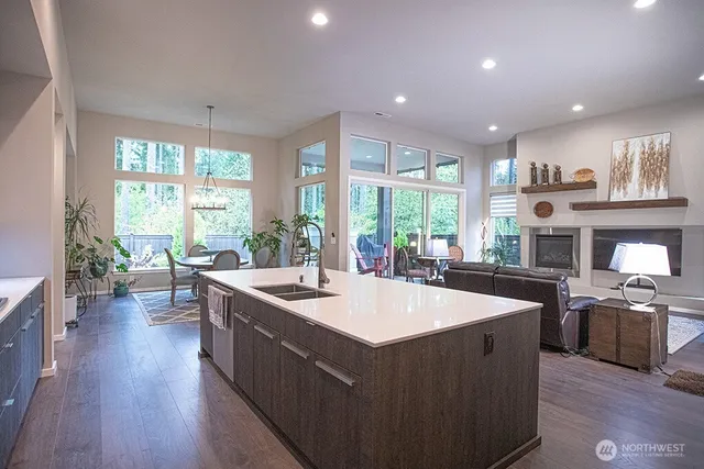 a kitchen with stainless steel appliances granite countertop a refrigerator and a sink