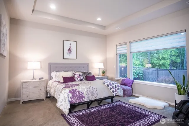 a bedroom with furniture and a flat screen tv