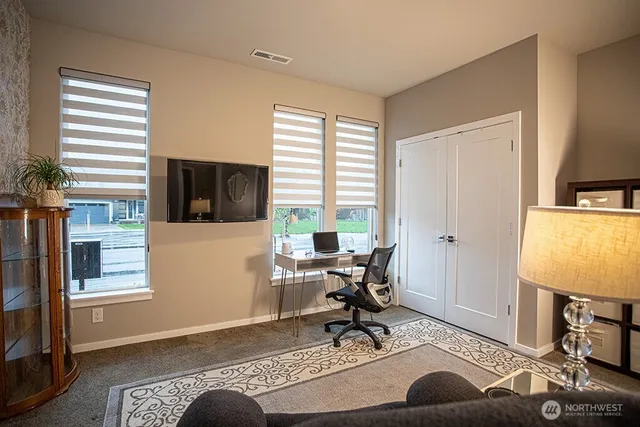 a living room with furniture a rug entryway and a window