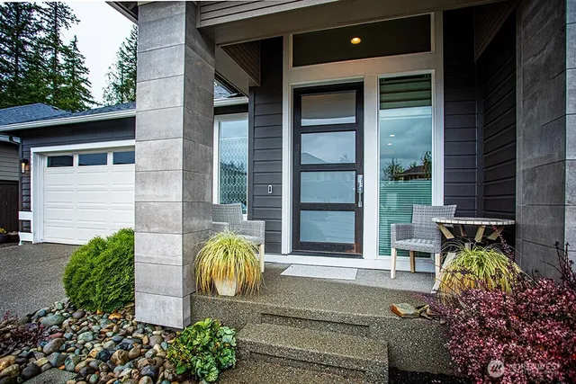a front view of a house with outdoor seating and plants