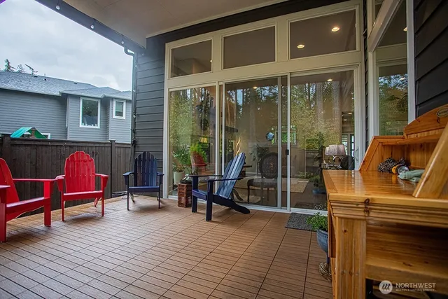 a view of a house with a small pool and a yard in front of it