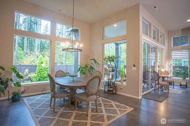 a view of a dining room with furniture window and wooden floor