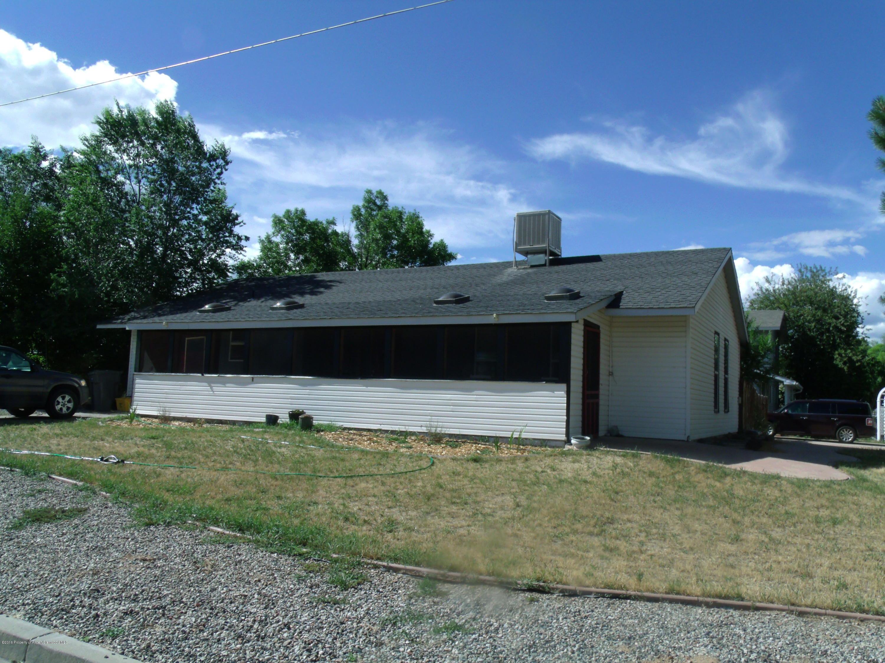 1202 West 5th Street Rifle, CO 81650 - Photo 1 of 14 a front view of a house with a yard