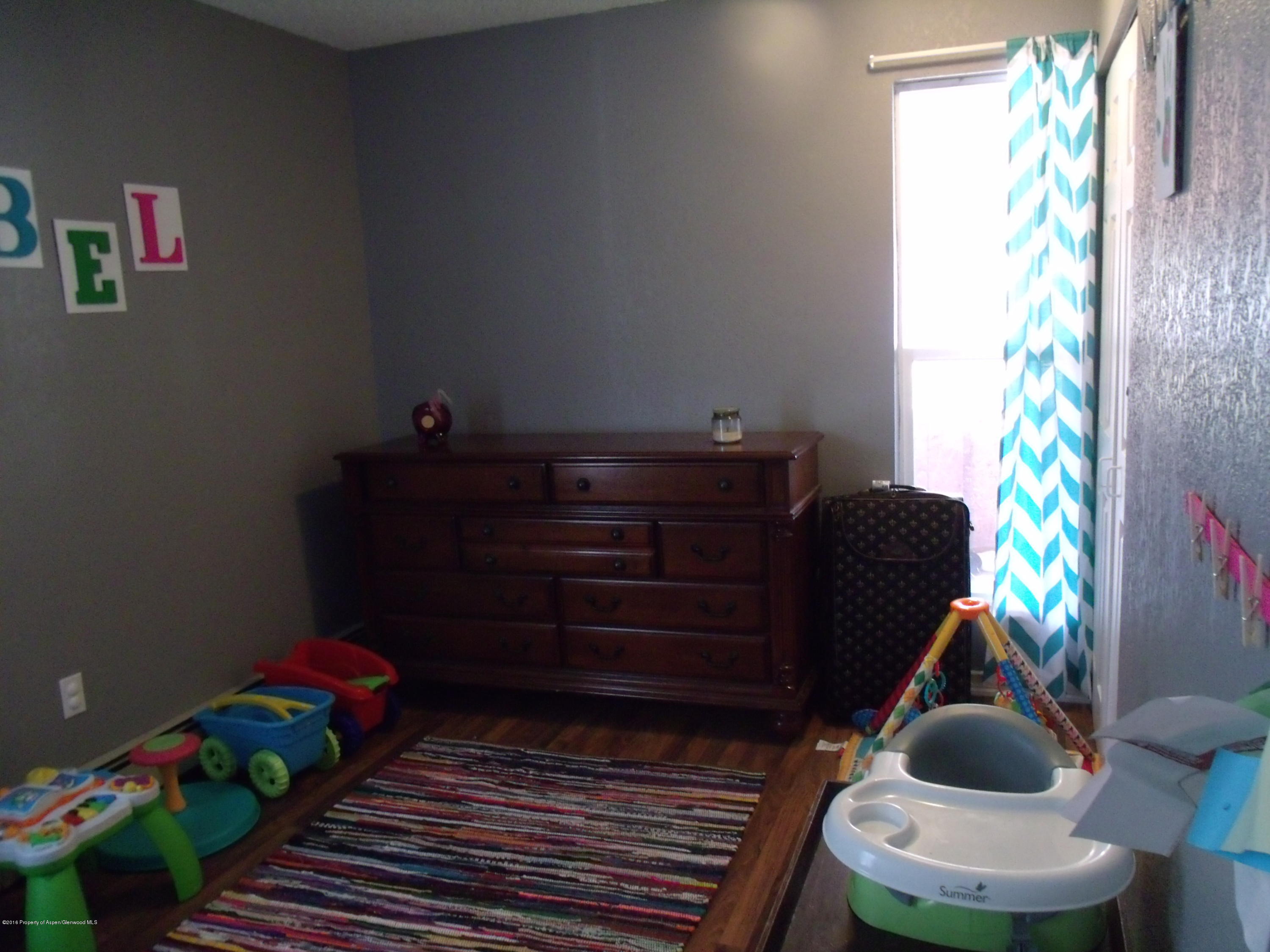 1202 West 5th Street Rifle, CO 81650 - Photo 11 of 14 a room with toys and wooden floor