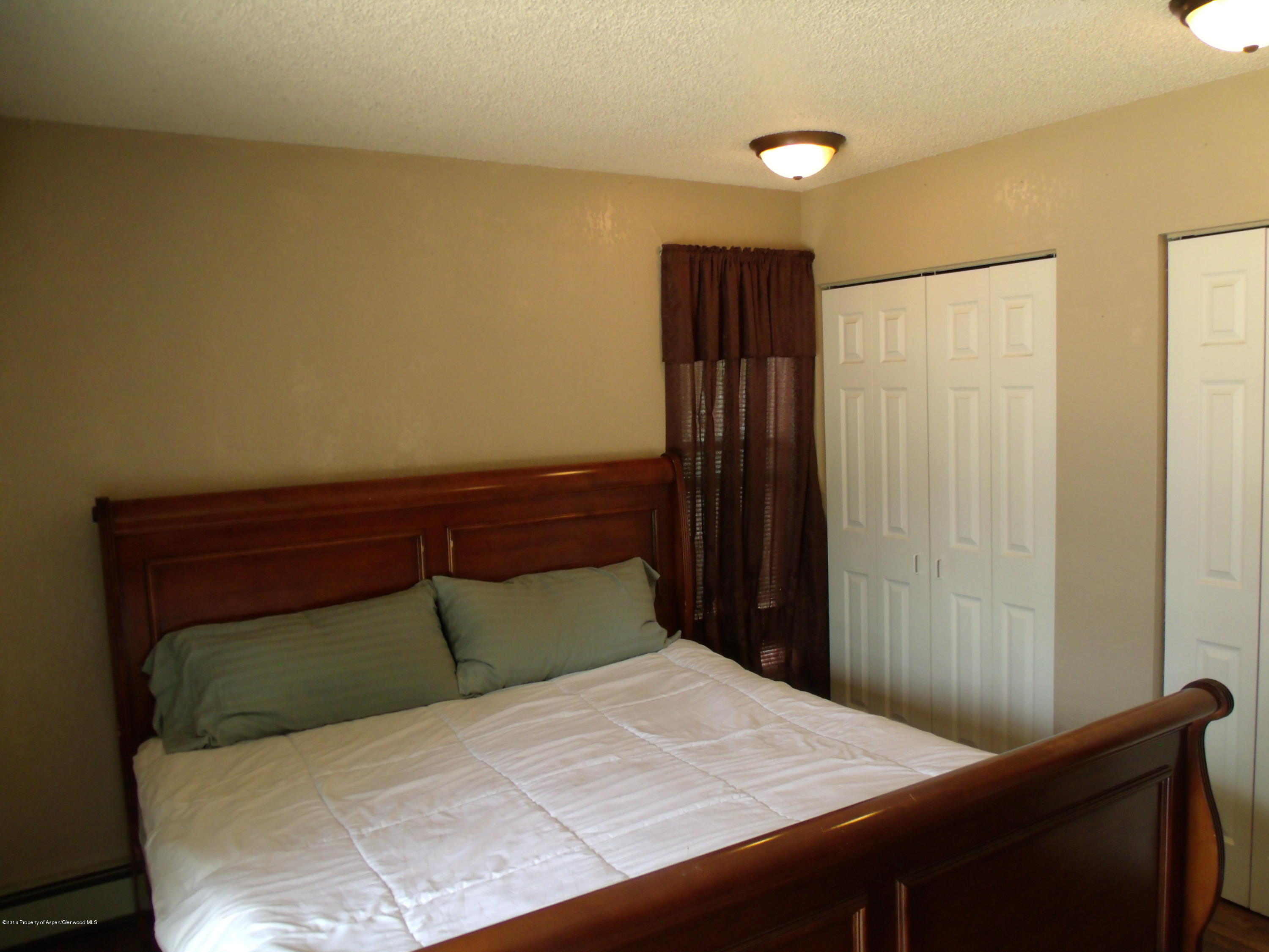 1202 West 5th Street Rifle, CO 81650 - Photo 13 of 14 a bedroom with a bed and a closet