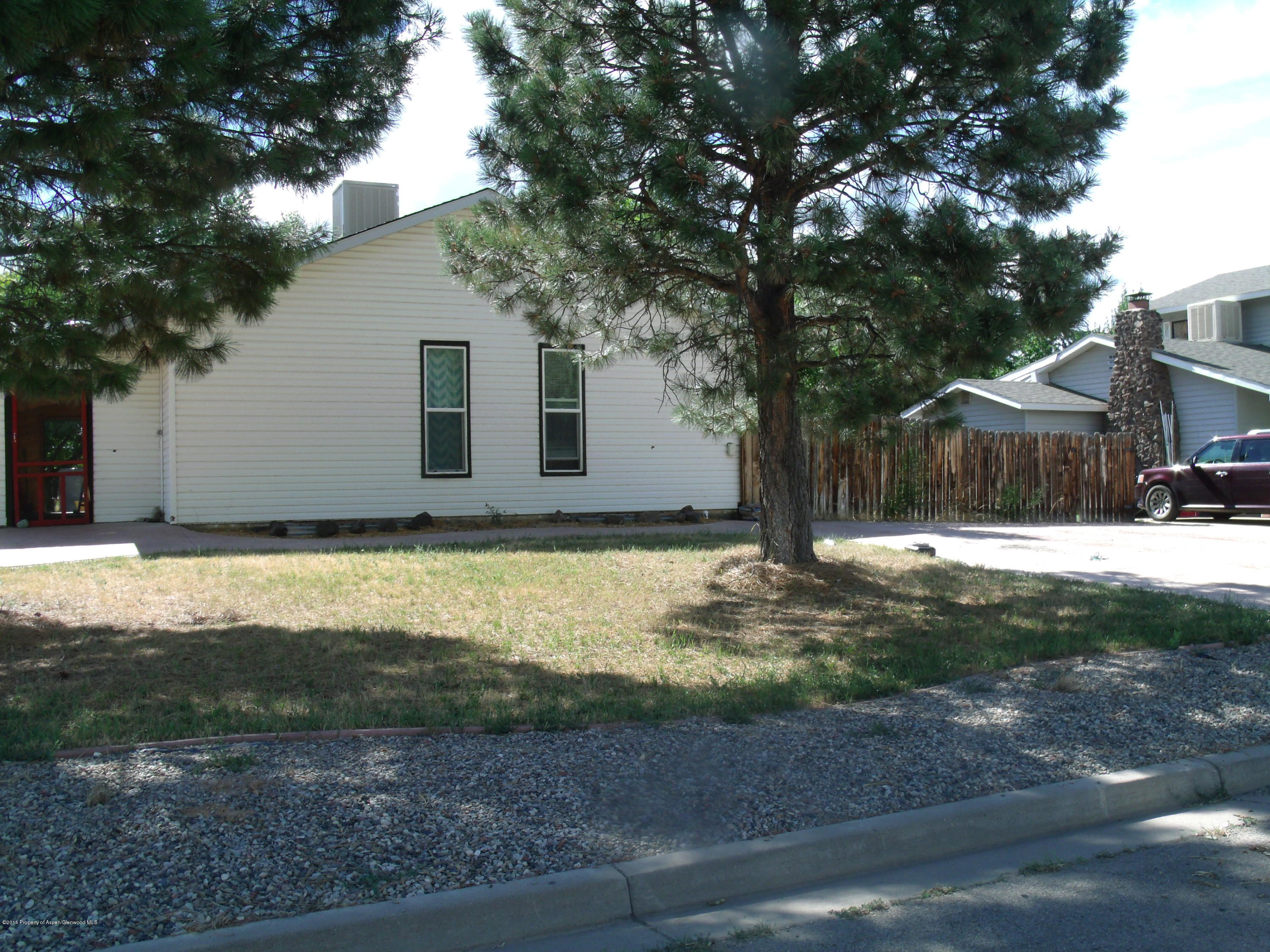 1202 West 5th Street Rifle, CO 81650 - Photo 3 of 14 a house with a tree in front of it