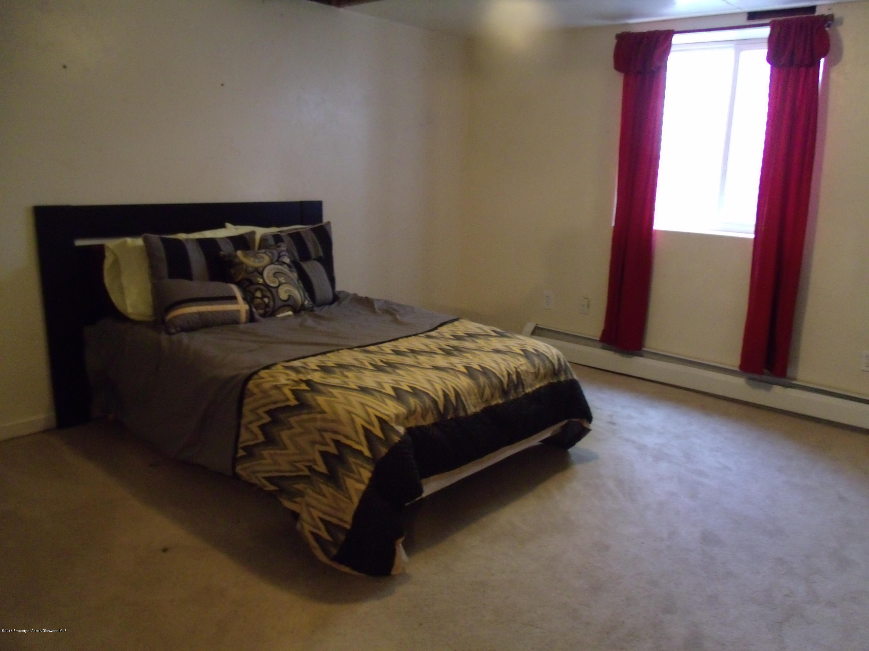 1202 West 5th Street Rifle, CO 81650 - Photo 8 of 14 a bedroom with a bed and window