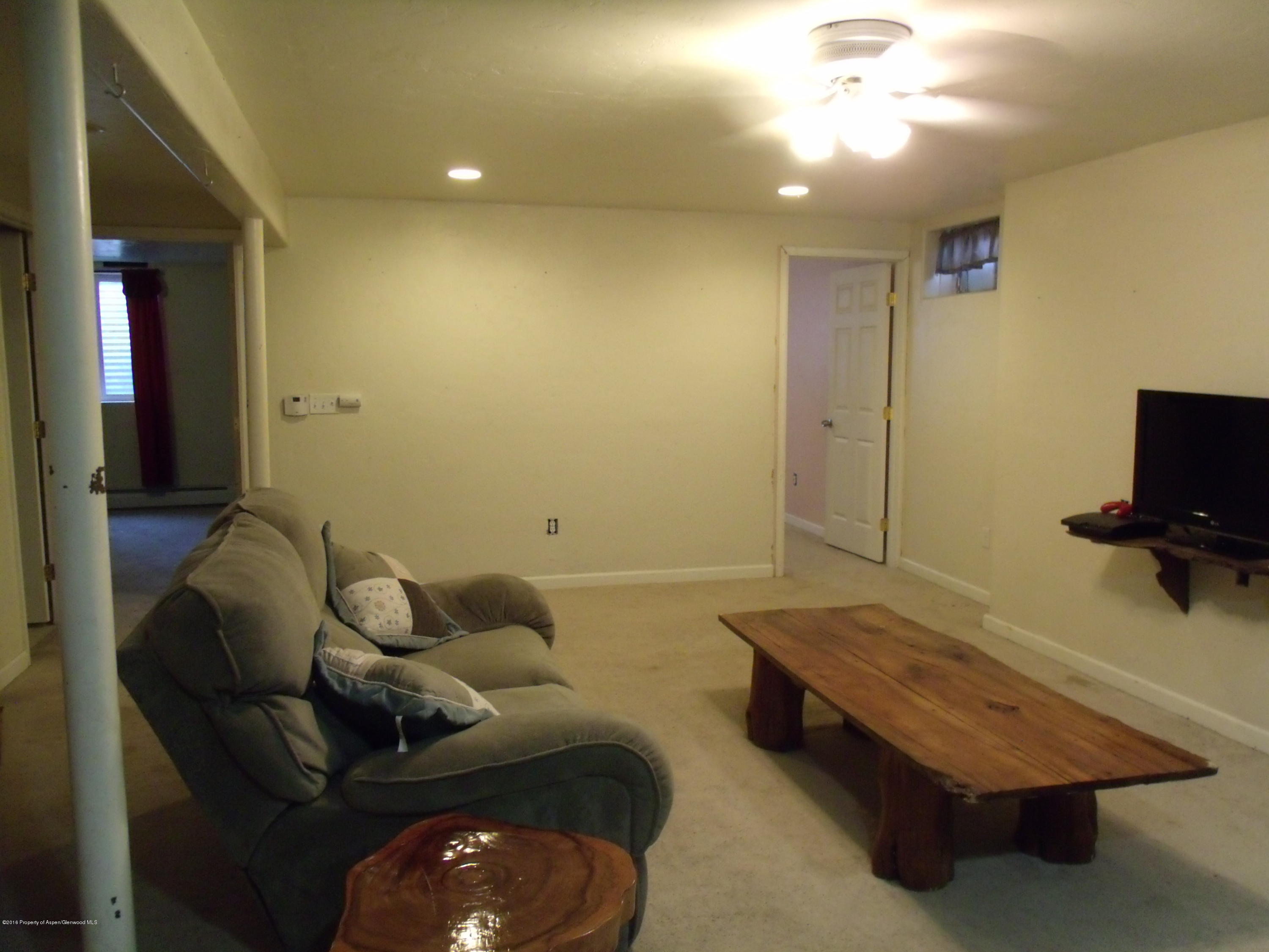 1202 West 5th Street Rifle, CO 81650 - Photo 10 of 14 a living room with furniture and a flat screen tv