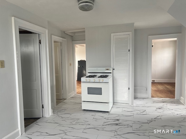 a kitchen with a stove and a refrigerator